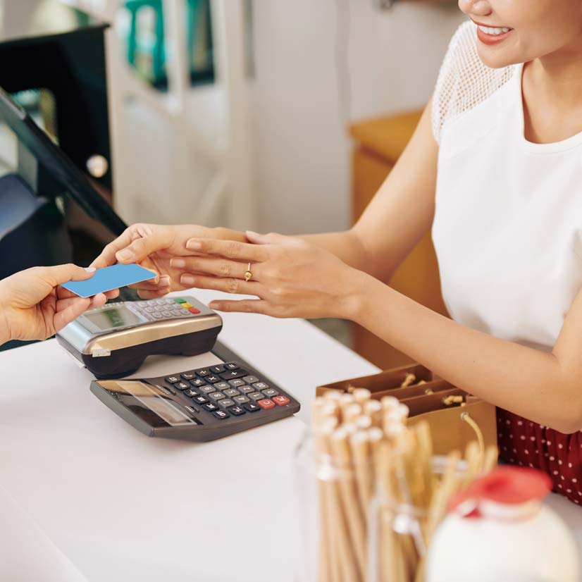 Customer paying with a credit card at a retail checkout counter