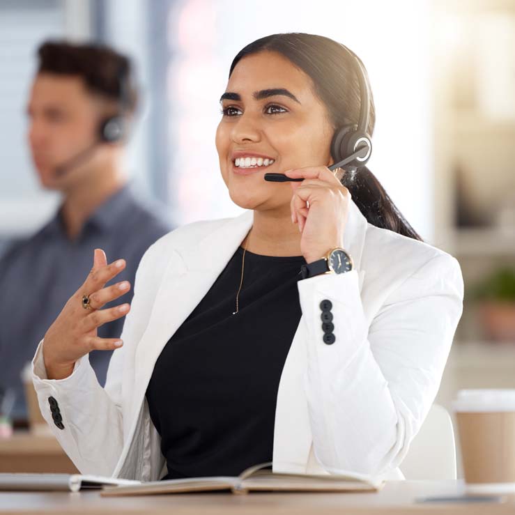 PaySave support representative wearing a headset at a call center workstation